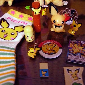 This is my misc Pichu stuff. There are Pichu socks... which are too small for me, a few keychains, a mighty beans thing, disc, stickers, Pichu and Pik