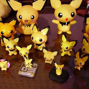 My Pichu figures! That one at the back left is a piggy bank. I have two of the same figure in here, too. Also one is a bobble head. And I love that on