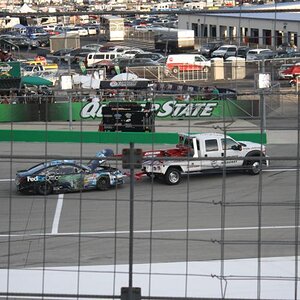 Denny Hamlin's #11 FedEx Toyota Camry being towed away as he hit the turn 4 wall during the 11th lap of the race.
Quaker State 400.
Sparta, Kentucky. 
